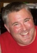 Smiling man in red shirt
